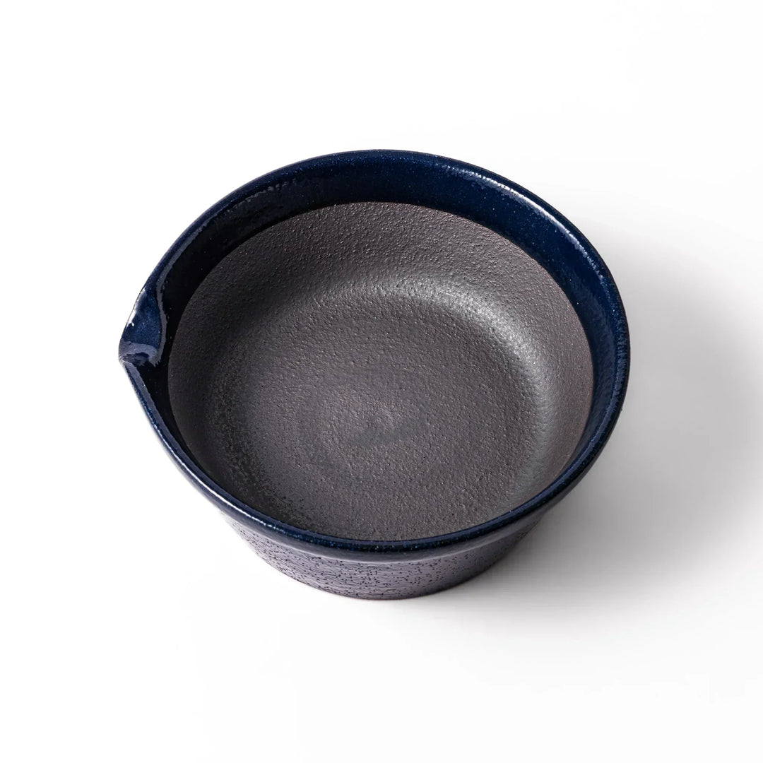 Deep blue Japanese ceramic suribachi bowl with smooth interior and spout for grinding and serving sauces.