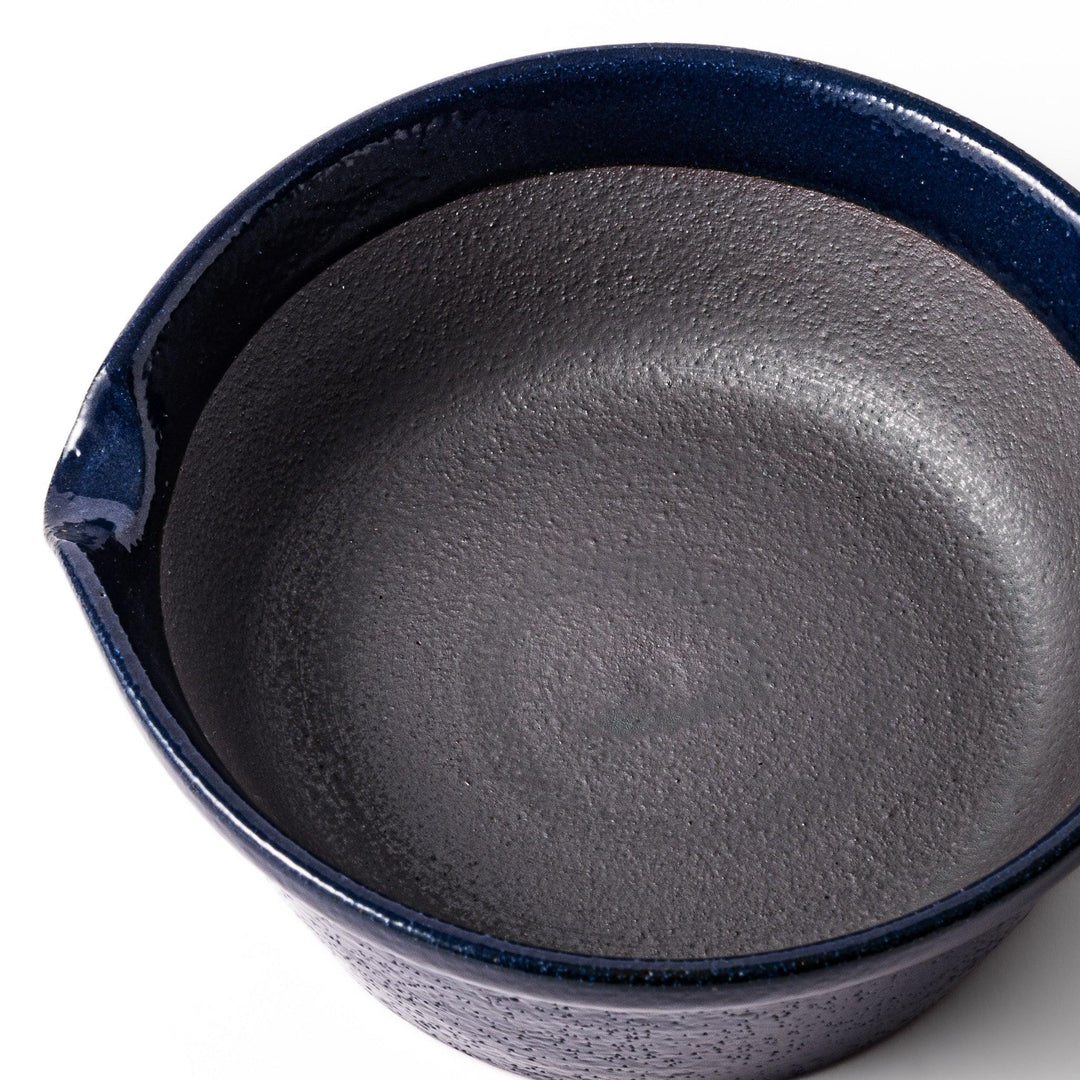 Deep blue Japanese ceramic suribachi bowl with smooth interior and spout for grinding and serving sauces.