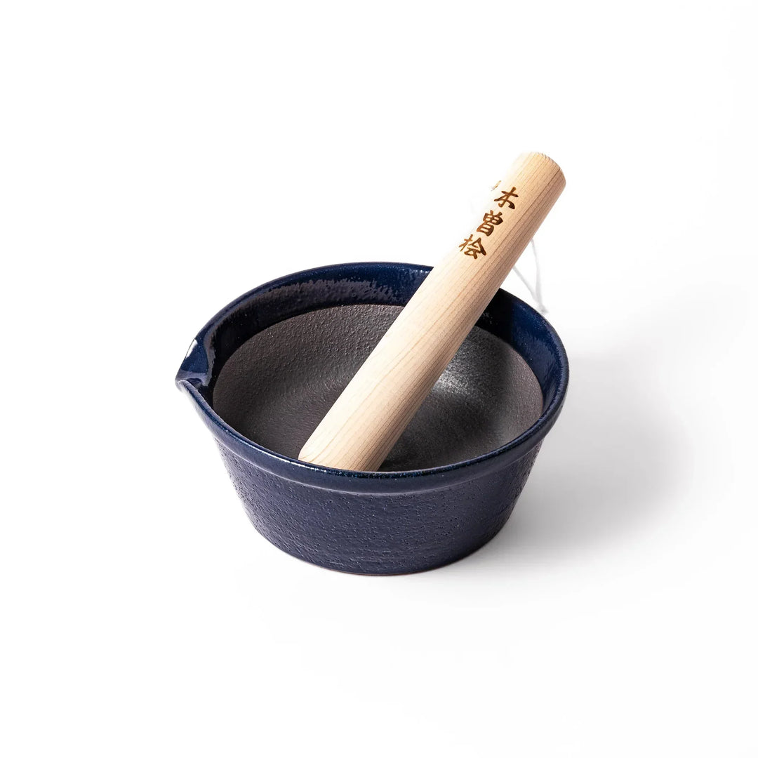 Deep blue Japanese ceramic suribachi bowl with smooth interior and spout for grinding and serving sauces.