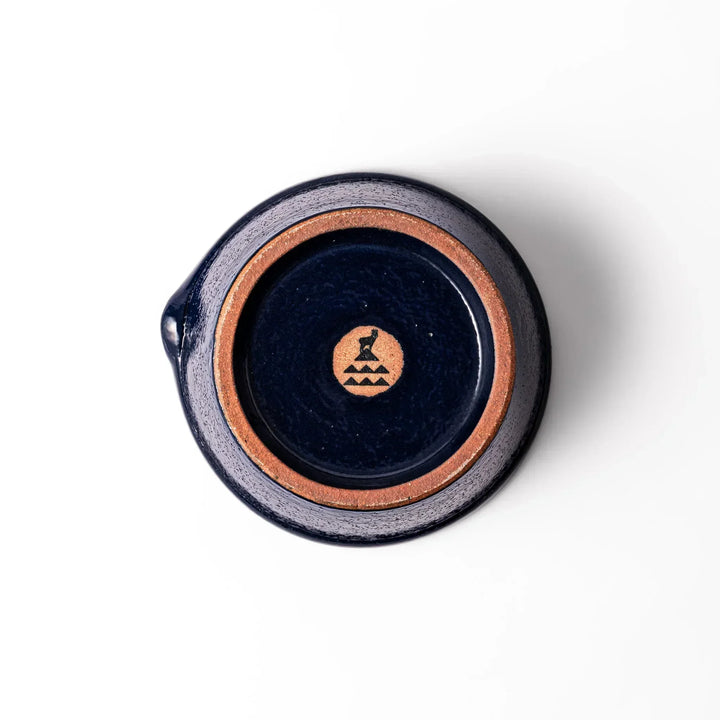 Deep blue Japanese ceramic suribachi bowl with smooth interior and spout for grinding and serving sauces.