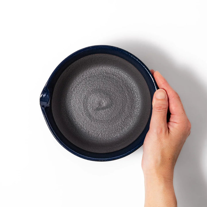 Deep blue Japanese ceramic suribachi bowl with smooth interior and spout for grinding and serving sauces.