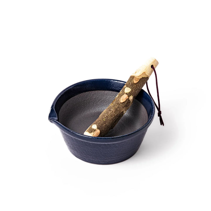 Deep blue Japanese ceramic suribachi bowl with smooth interior and spout for grinding and serving sauces.