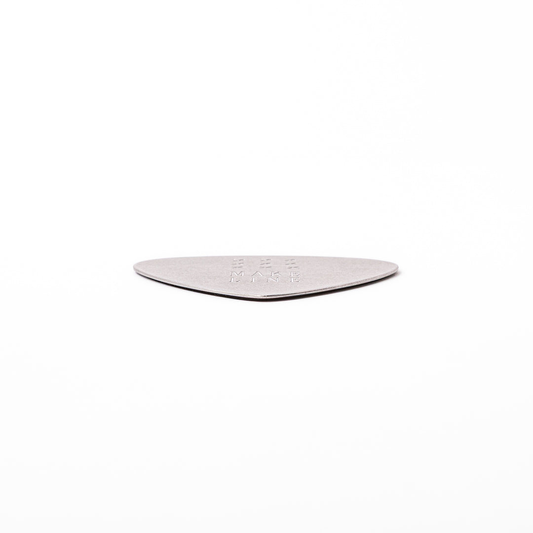 Unique guitar pick shaped metal coaster with vintage matte finish engraved with make line text and cross patterns