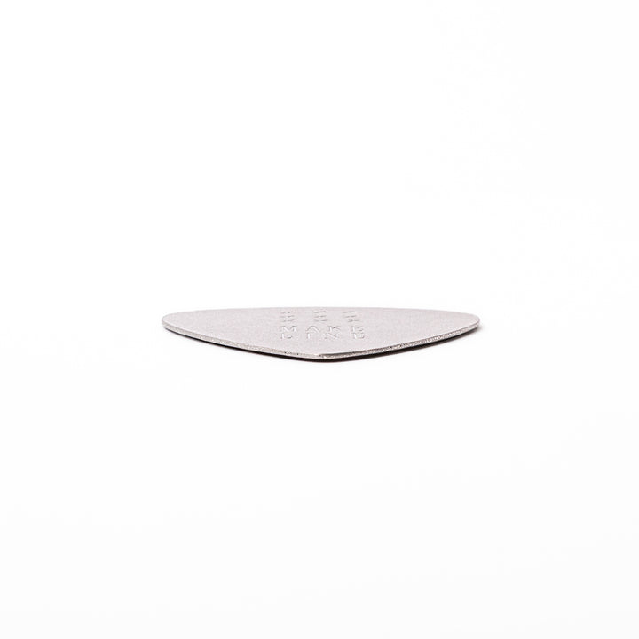 Unique guitar pick shaped metal coaster with sandblasted textured finish engraved with make line text and cross patterns