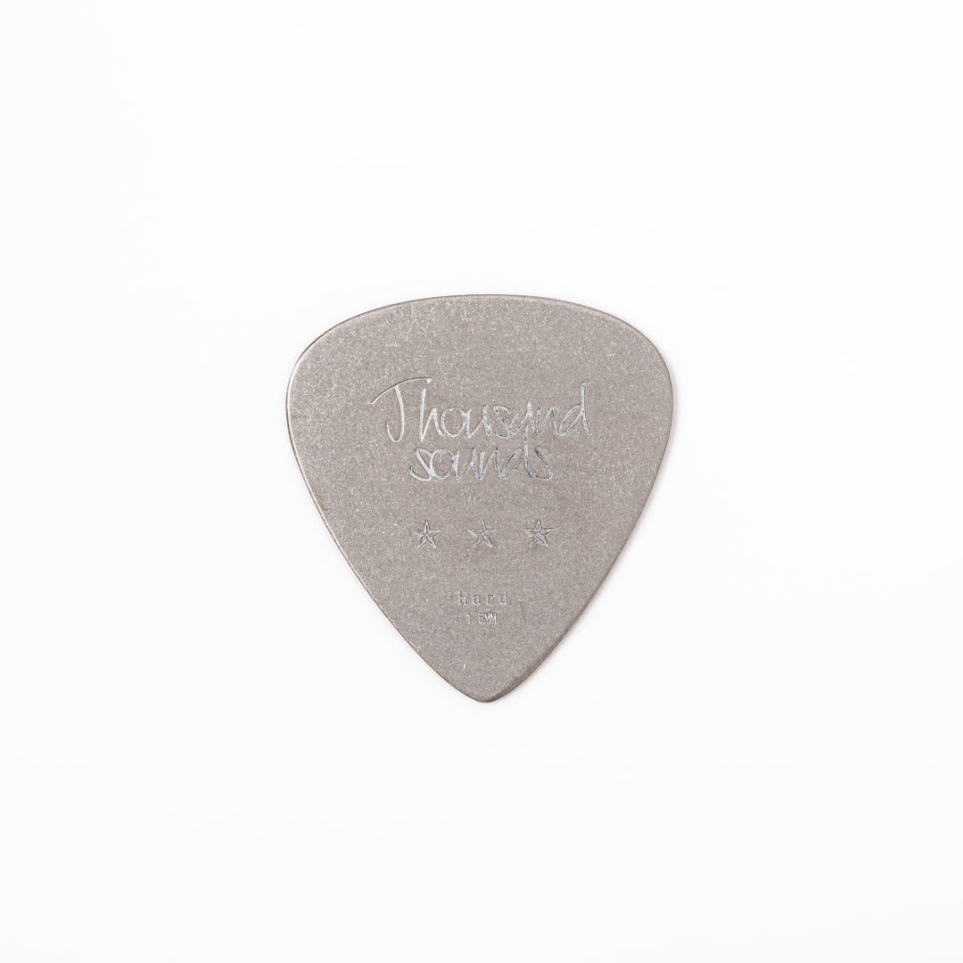 Unique guitar pick shaped metal coaster with vintage matte finish engraved with thousand sounds text and stars