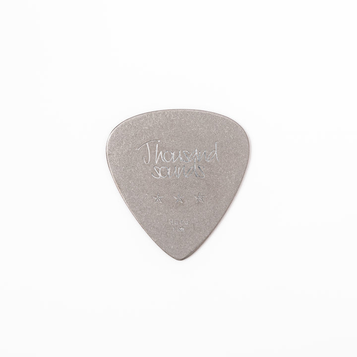 Unique guitar pick shaped metal coaster with vintage matte finish engraved with thousand sounds text and stars