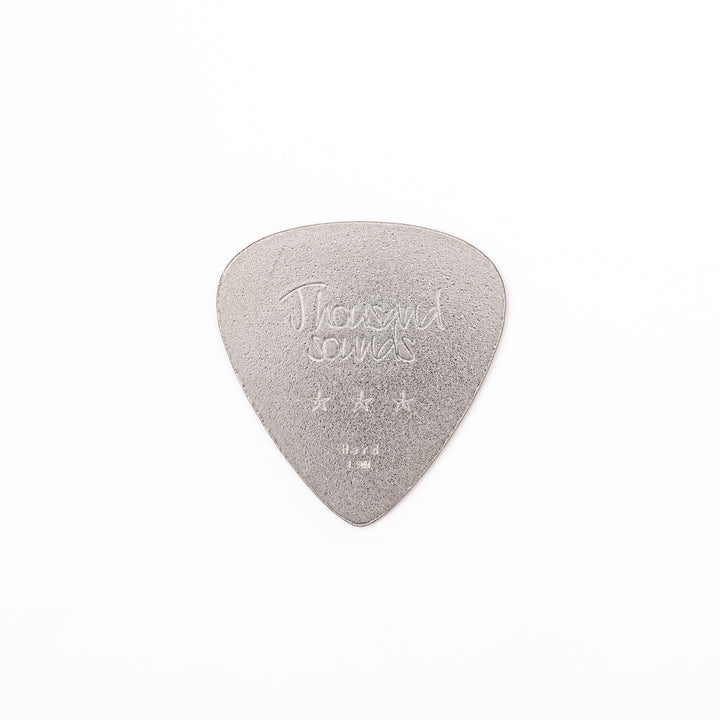 Unique guitar pick shaped metal coaster with sandblasted textured finish engraved with thousand sounds text and stars