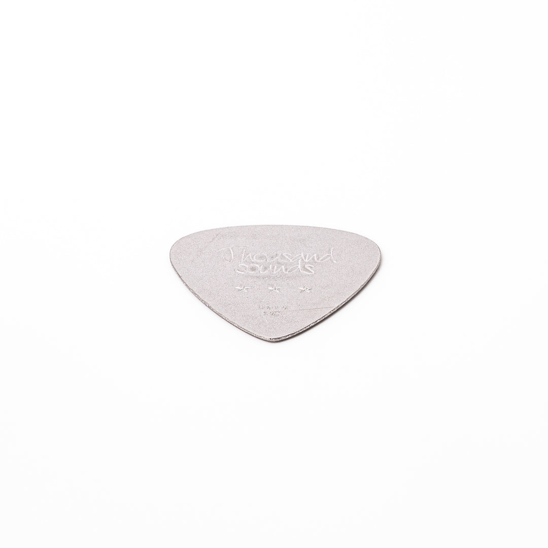Unique guitar pick shaped metal coaster with sandblasted textured finish engraved with thousand sounds text and stars
