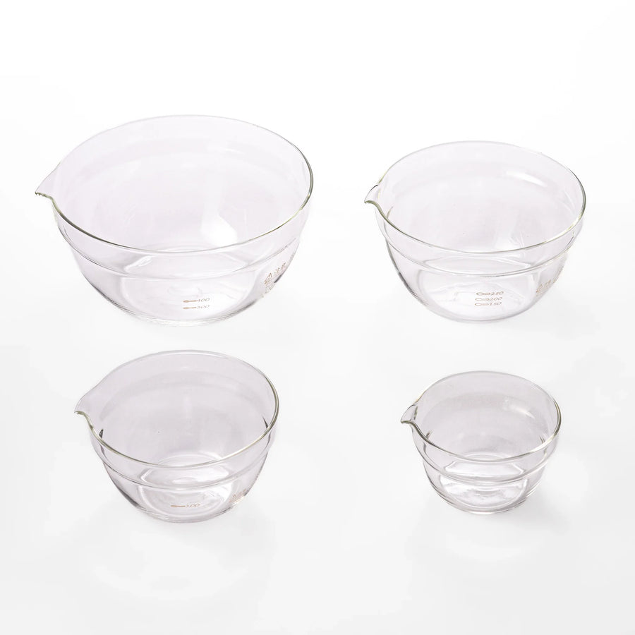 Set of four HARIO heat resistant glass mixing bowls with pour spouts, featuring various nested sizes for easy meal prep