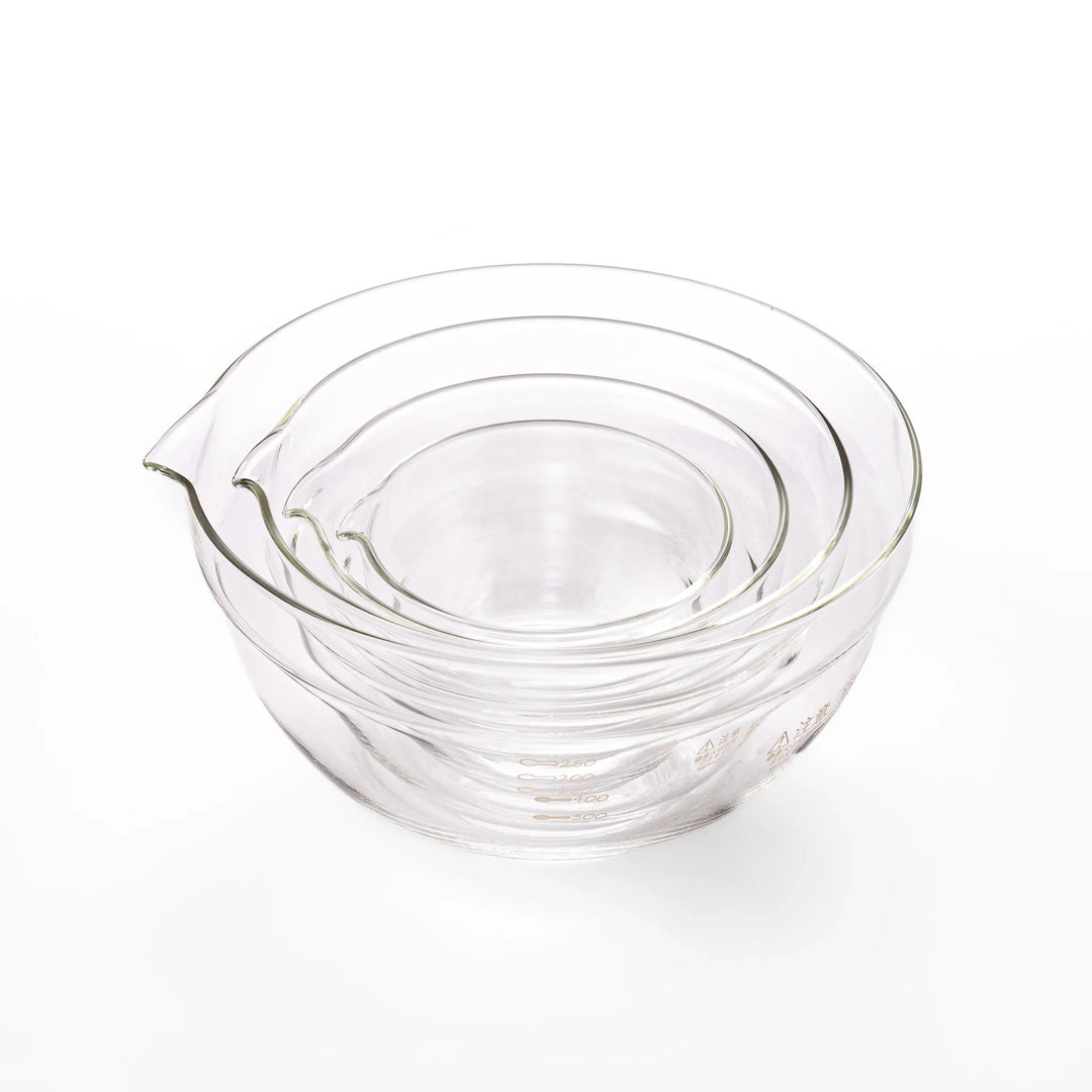 Set of four HARIO heat resistant glass mixing bowls with pour spouts, featuring various nested sizes for easy meal prep