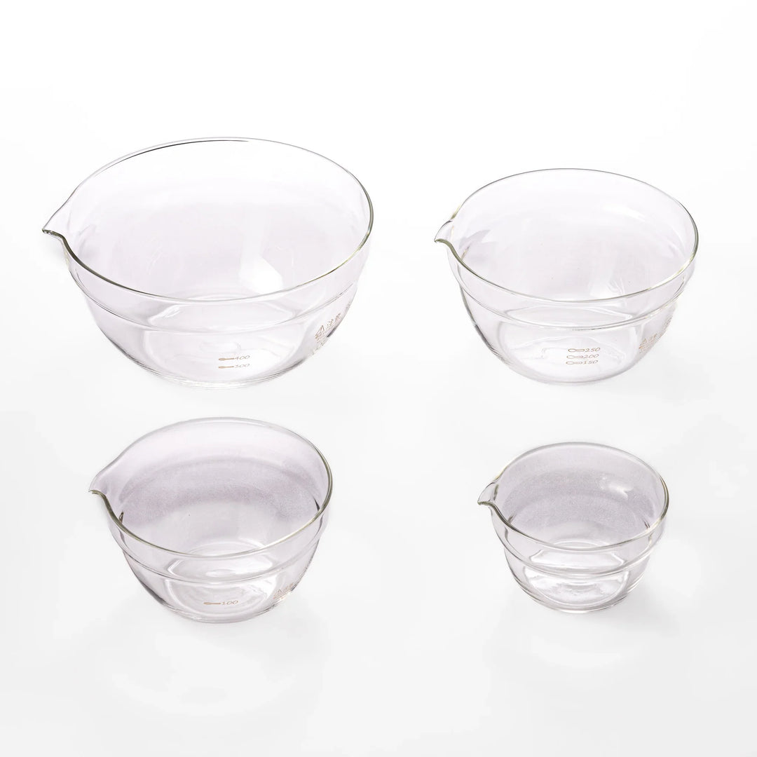 Set of four HARIO heat resistant glass mixing bowls with pour spouts, featuring various nested sizes for easy meal prep