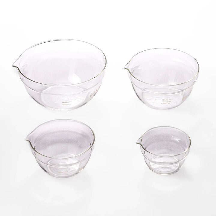 Set of four HARIO heat resistant glass mixing bowls with pour spouts, featuring various nested sizes for easy meal prep