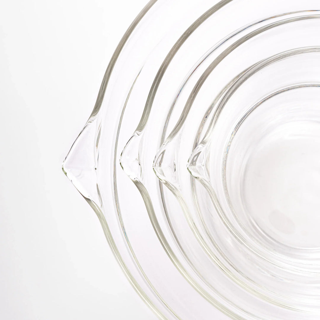 Set of four HARIO heat resistant glass mixing bowls with pour spouts, featuring various nested sizes for easy meal prep