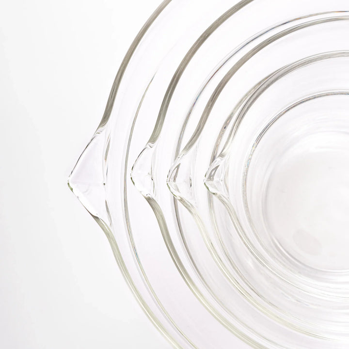 Set of four HARIO heat resistant glass mixing bowls with pour spouts, featuring various nested sizes for easy meal prep