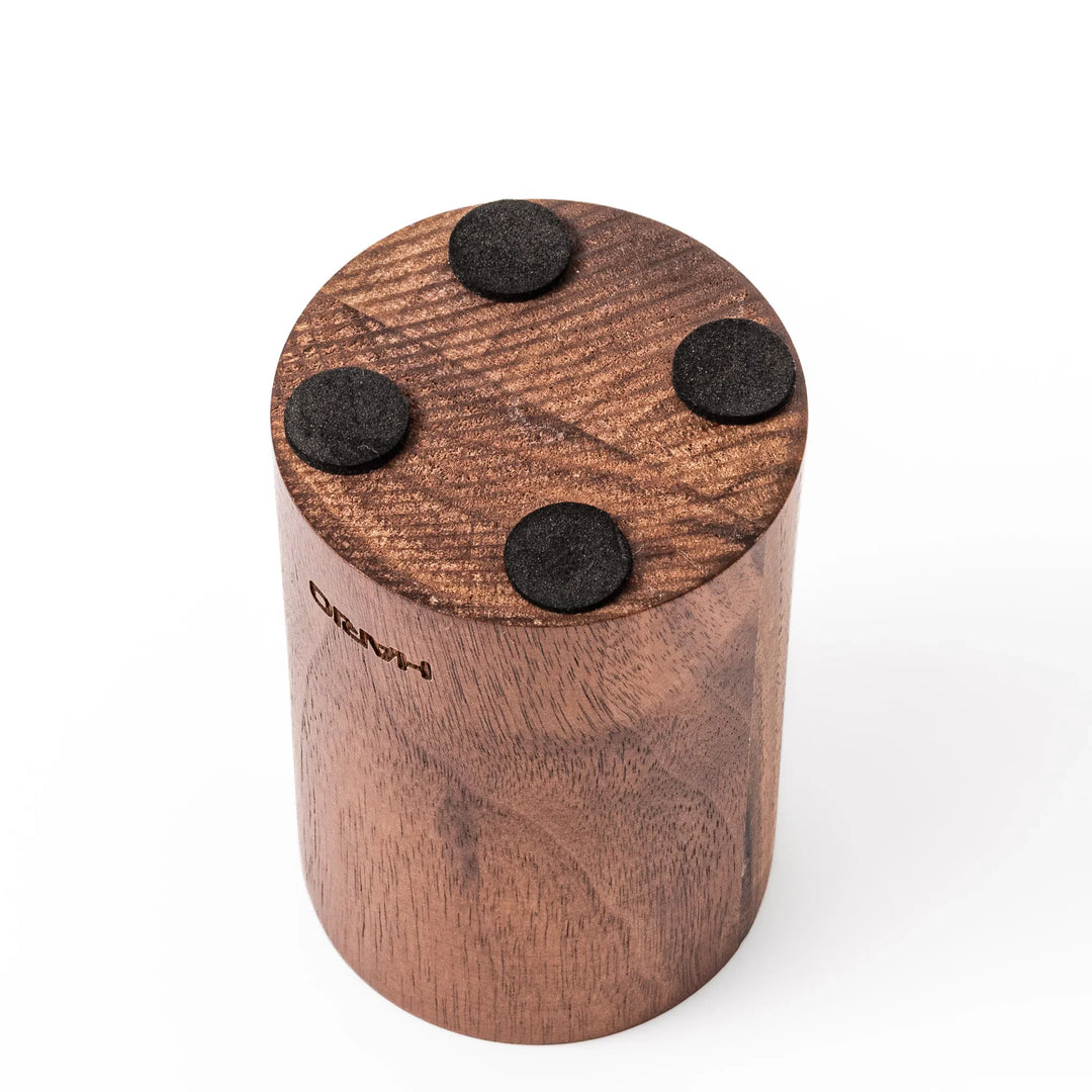 HARIO walnut wood manual coffee grinder with a hand crank, featuring a sleek natural wooden body on a white background