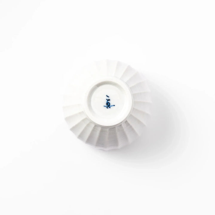 White teacup with vertical petal grooves and glossy finish perfect for serving hot tea in modern style.