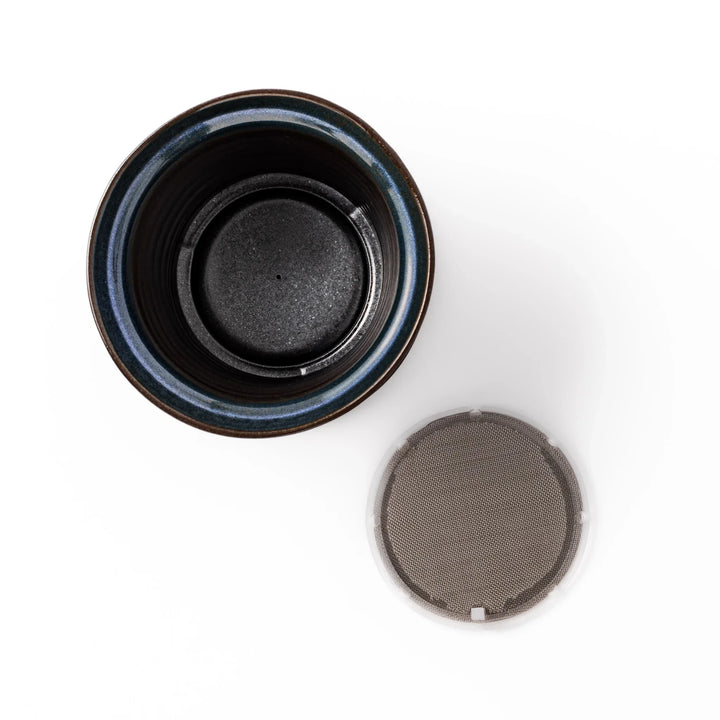 Handcrafted ceramic coffee dripper in brown and blue glaze with mesh filter for single serve brewing.
