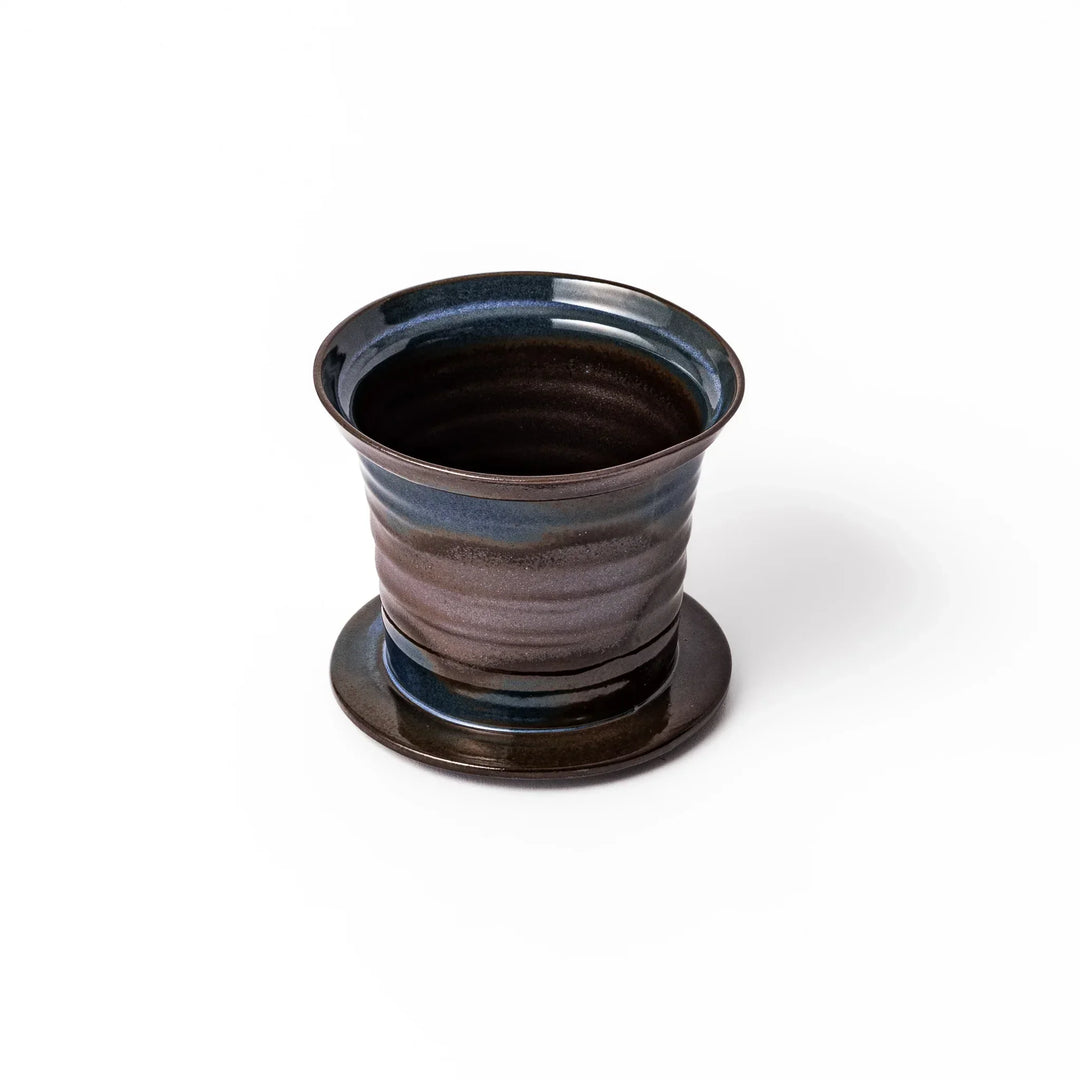 Handcrafted ceramic coffee dripper in brown and blue glaze with mesh filter for single serve brewing.
