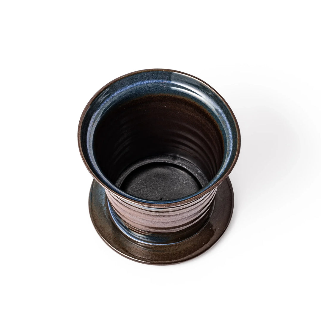 Handcrafted ceramic coffee dripper in brown and blue glaze with mesh filter for single serve brewing.