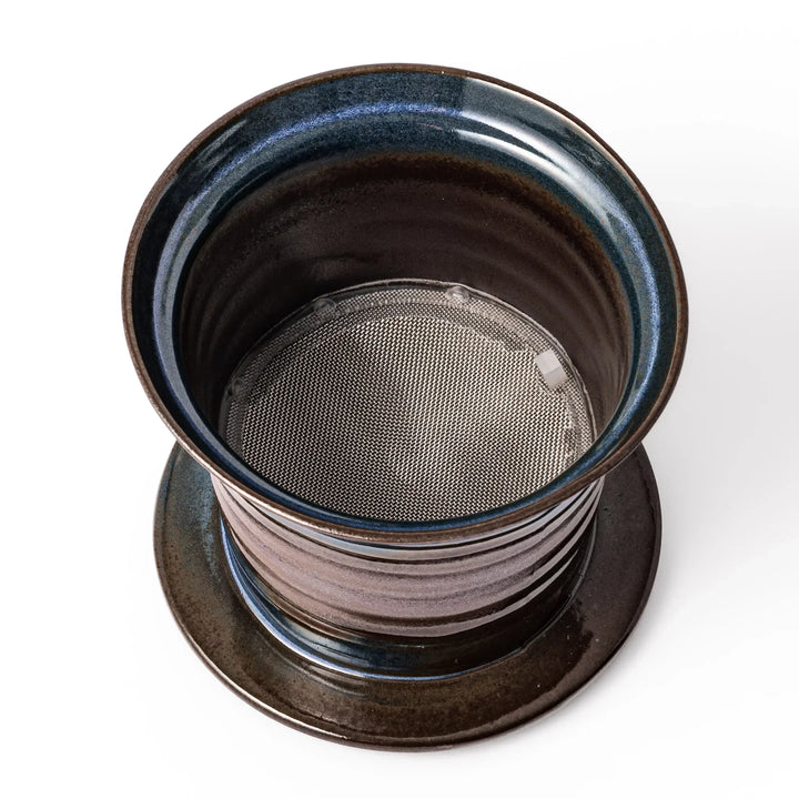 Handcrafted ceramic coffee dripper in brown and blue glaze with mesh filter for single serve brewing.