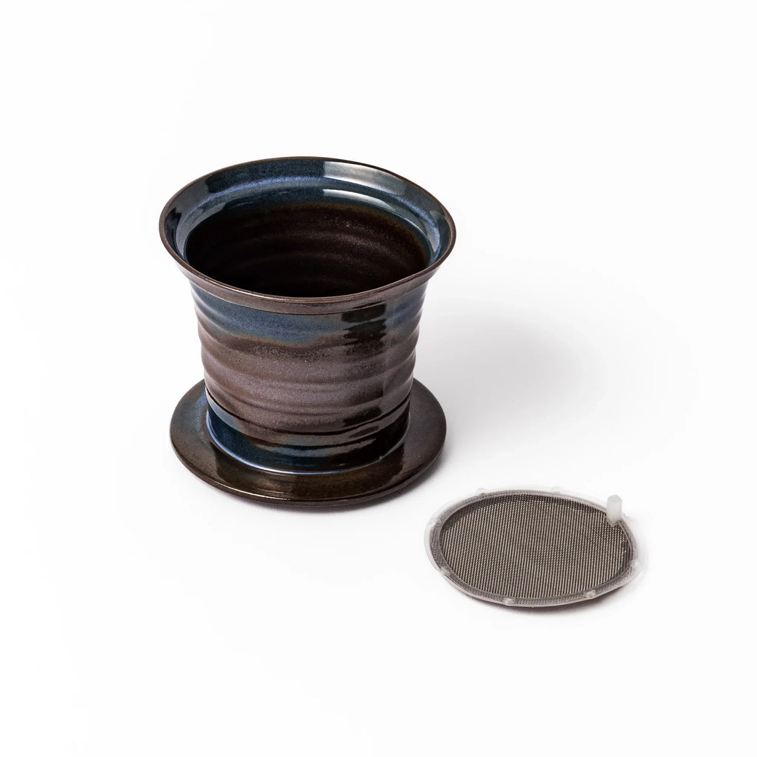 Handcrafted ceramic coffee dripper in brown and blue glaze with mesh filter for single serve brewing.