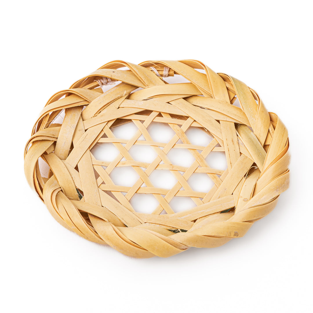 A round handwoven bamboo drink coaster showcasing a traditional star pattern weave and a braided natural fiber border