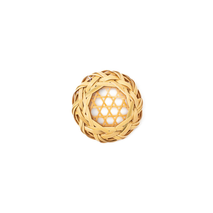 A round handwoven bamboo drink coaster showcasing a traditional star pattern weave and a braided natural fiber border