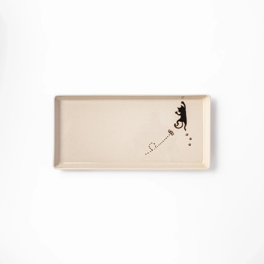 Beige rectangular ceramic plate featuring a playful black cat illustration with paw prints and a butterfly in the corner.