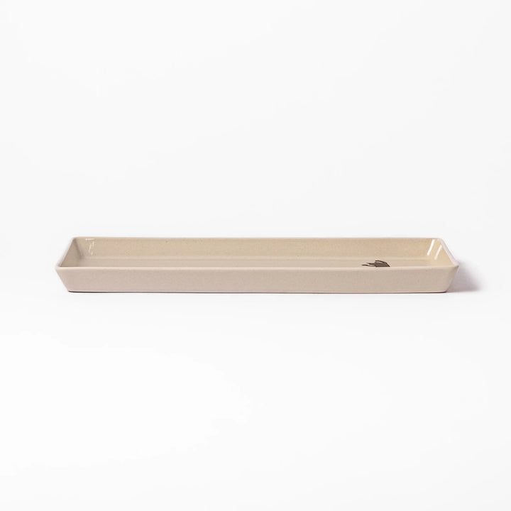 Beige rectangular ceramic plate featuring a playful black cat illustration with paw prints and a butterfly in the corner.