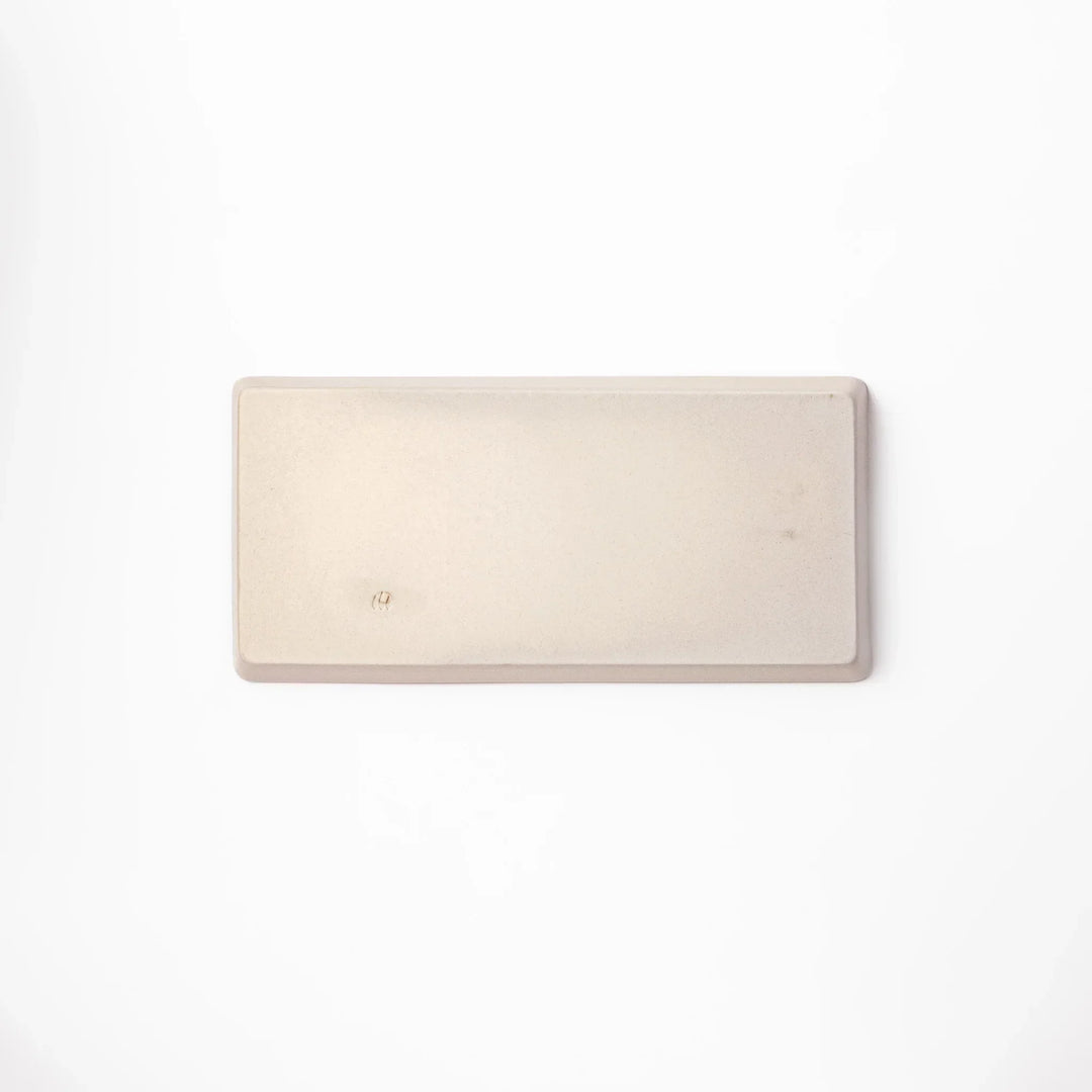 Beige rectangular ceramic plate featuring a playful black cat illustration with paw prints and a butterfly in the corner.