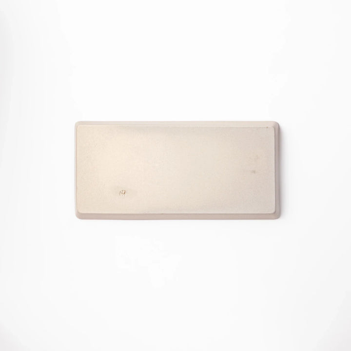 Beige rectangular ceramic plate featuring a playful black cat illustration with paw prints and a butterfly in the corner.