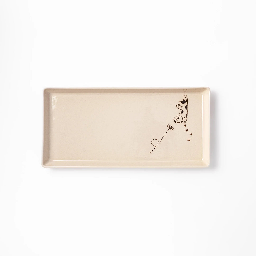 Beige rectangular ceramic plate featuring a playful calico cat illustration with paw prints and a butterfly in the corner.