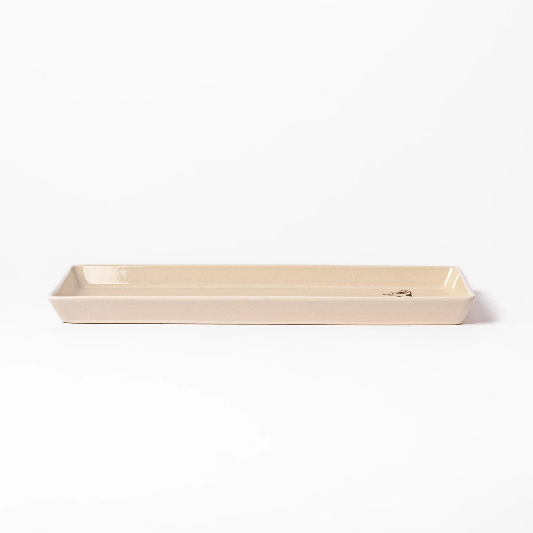 Beige rectangular ceramic plate featuring a playful calico cat illustration with paw prints and a butterfly in the corner.