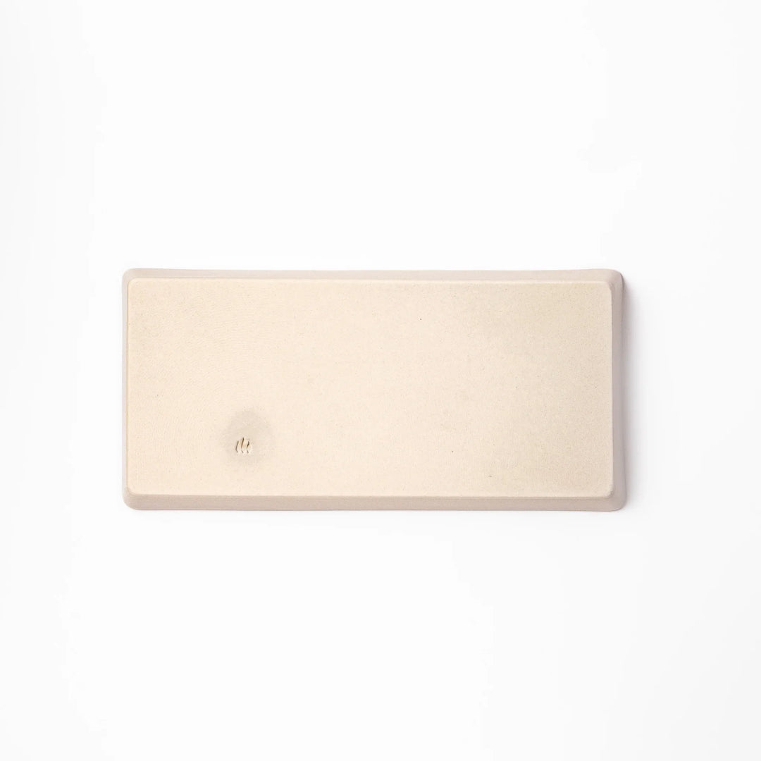 Beige rectangular ceramic plate featuring a playful calico cat illustration with paw prints and a butterfly in the corner.