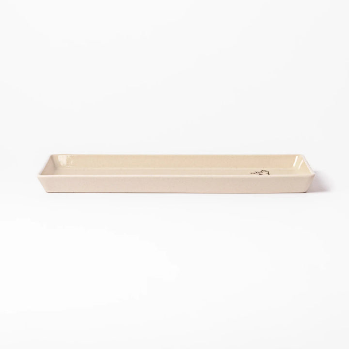 Beige rectangular ceramic plate featuring a playful tabby cat illustration with paw prints and a butterfly in the corner.