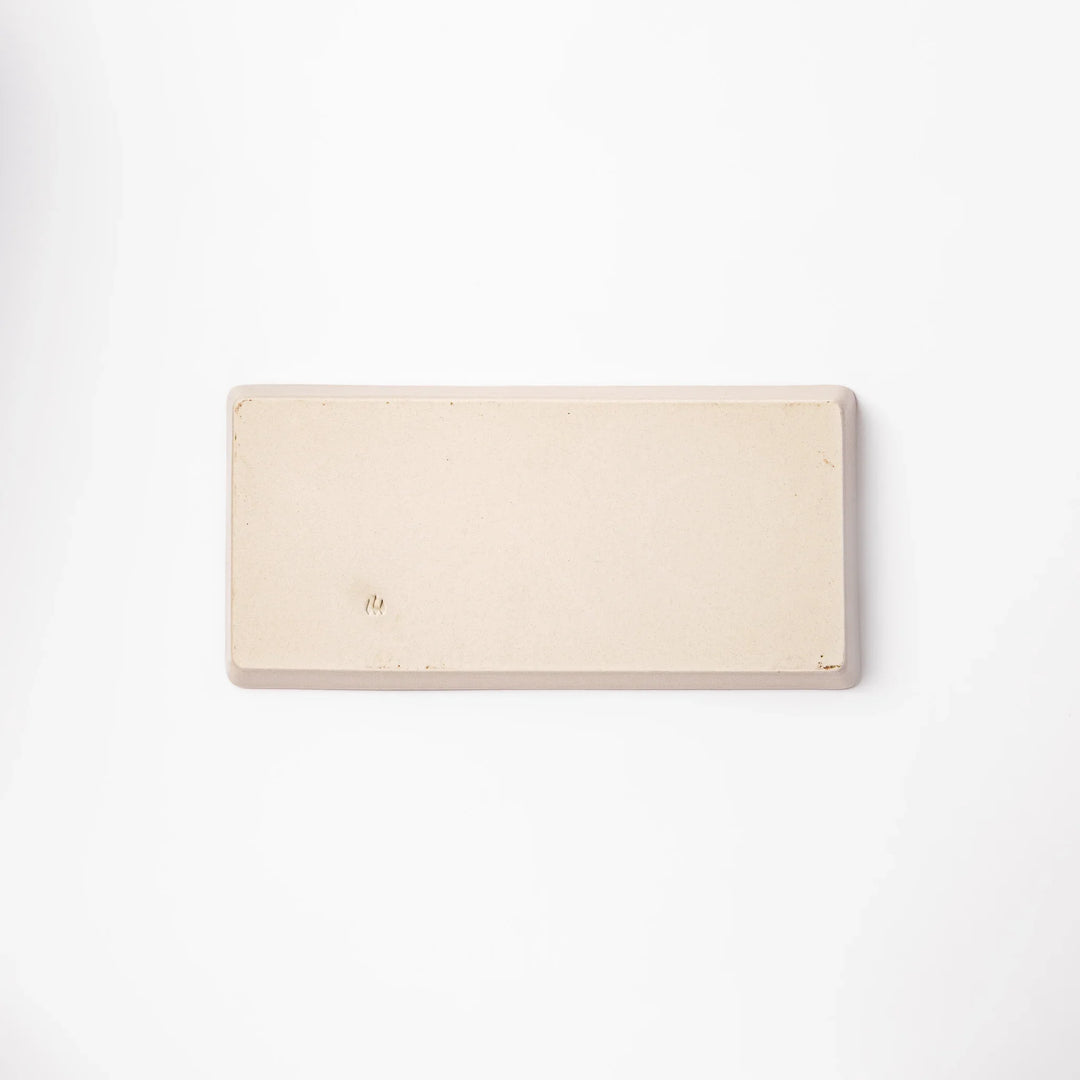 Beige rectangular ceramic plate featuring a playful tabby cat illustration with paw prints and a butterfly in the corner.