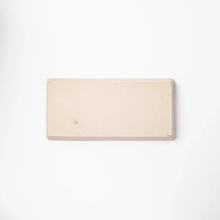 Beige rectangular ceramic plate featuring a playful tabby cat illustration with paw prints and a butterfly in the corner.