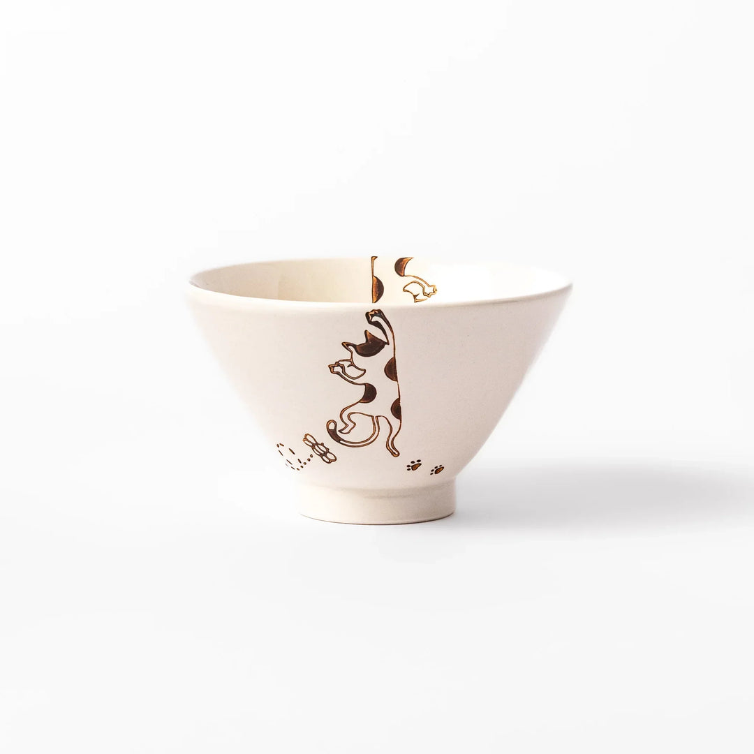 Cream-colored rice bowl with a calico hanging cat, butterfly, and playful paw prints on the outside and inner rim.