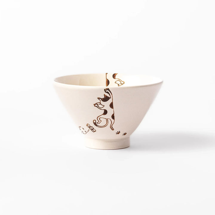 Cream-colored rice bowl with a calico hanging cat, butterfly, and playful paw prints on the outside and inner rim.