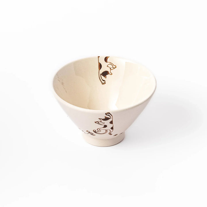 Cream-colored rice bowl with a calico hanging cat, butterfly, and playful paw prints on the outside and inner rim.