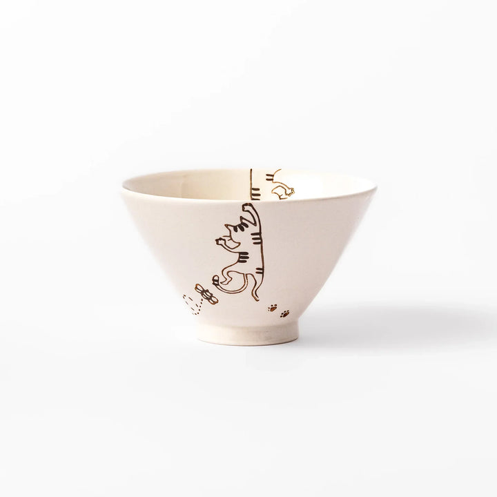 Cream-colored rice bowl with a striped hanging cat, butterfly, and dotted paw prints on the outer and inner surface.