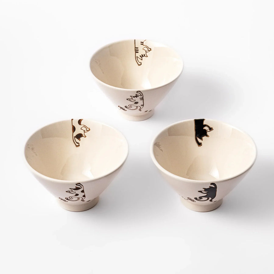 Set of three cream ceramic rice bowls with hanging cat designs in black calico and tabby with butterflies.