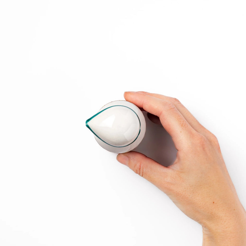 Japanese ceramic soy sauce dispenser with teal geometric blossom pattern in gold and red for refined dining.