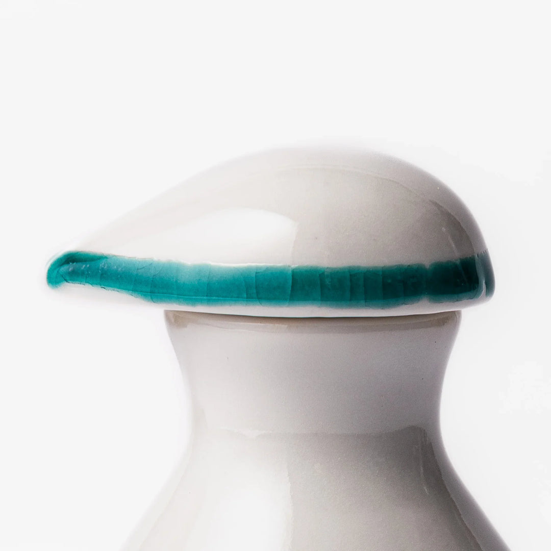 Japanese ceramic soy sauce dispenser with teal geometric blossom pattern in gold and red for refined dining.