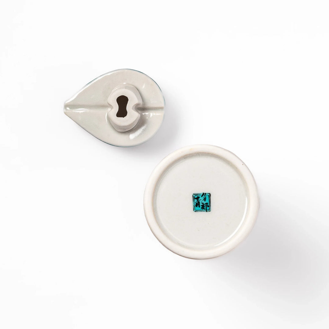 Japanese ceramic soy sauce dispenser with teal geometric blossom pattern in gold and red for refined dining.