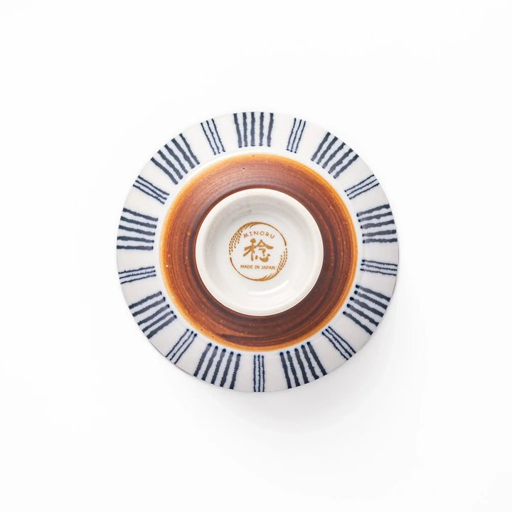 Japanese porcelain rice bowl with fine indigo vertical stripes and terracotta base in minimalist design.