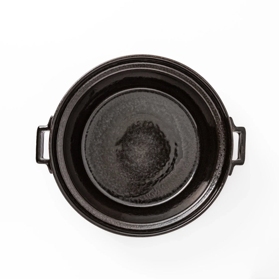 Black Japanese ceramic donabe with a fitted lid and side handles for family size hot pot and stovetop cooking