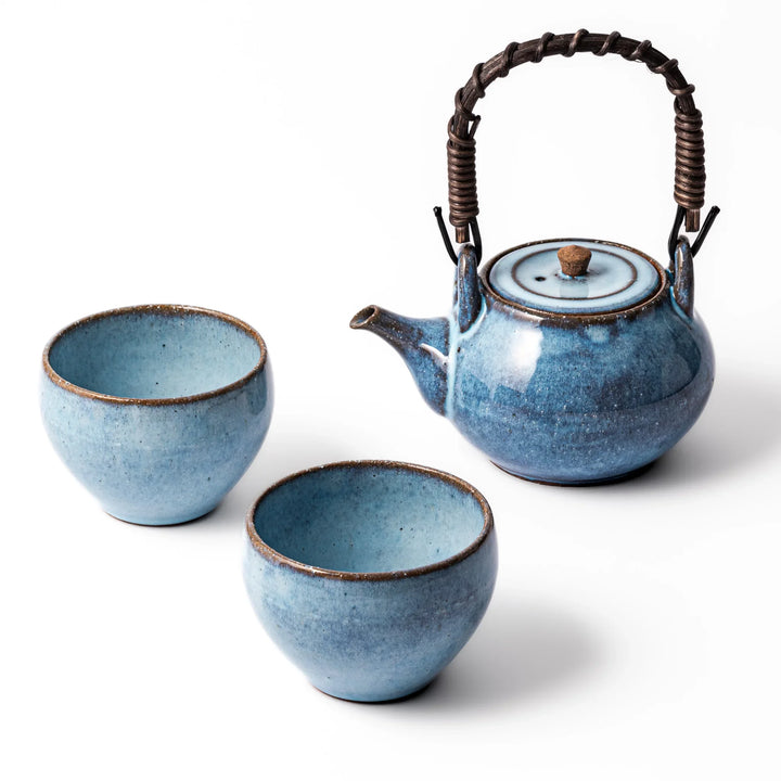 Hasami Indigo Horizon Tea Set with ceramic teapot and two cups showcasing rich indigo glaze and artistry.