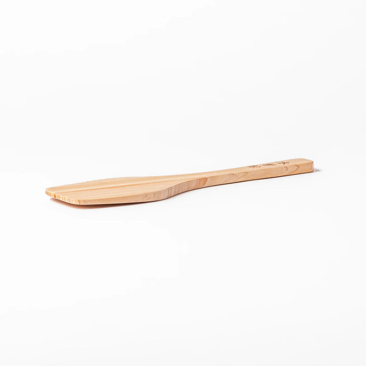 Compact hinoki wood spatula with flat angled edge and engraved handle for straining flipping and serving.
