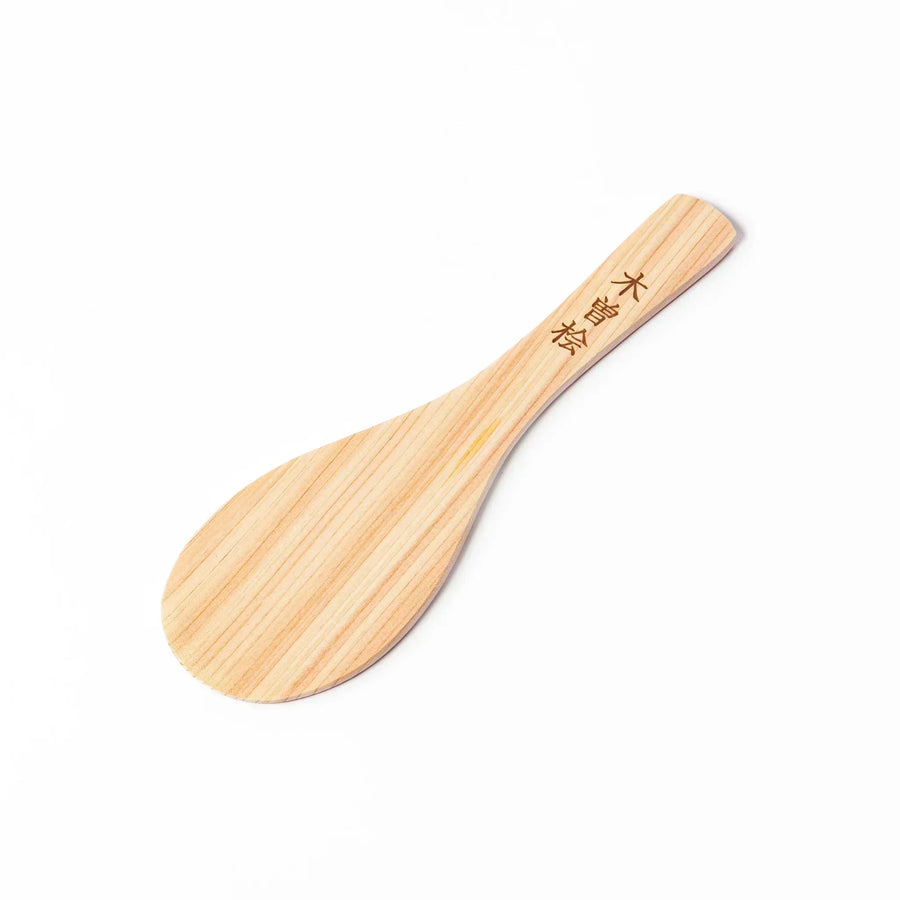 Japanese hinoki wood rice paddle with natural grain and engraved characters, lightweight and smooth for serving cooked rice